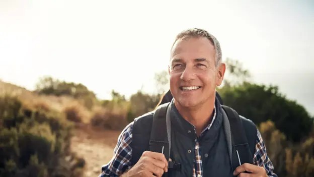 Man-with-gray-hair-hikes-outdoors